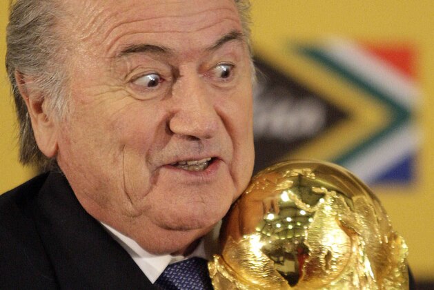 FILE - In this Sunday June 6, 2010 file photo FIFA President Joseph Blatter holds the trophy after receiving it back from South African President Jacob Zuma during a media briefing on the 2010 Soccer World Cup in Pretoria, South Africa.  FIFA President Sepp Blatter will resign from soccer's governing body amid a widening corruption scandal and promised Tuesday to call for fresh elections to choose a successor. (AP Photo/Themba Hadebe, File)