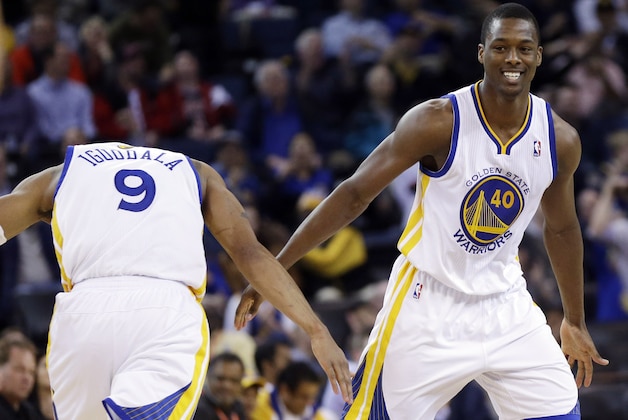 Golden State Warriors' Harrison Barnes celebrates with teammate Andre Iguodala during the second half of an NBA basketball game on Thursday, Feb. 6, 2014, in Oakland, Calif. Golden State won 102-87. (AP Photo/Marcio Jose Sanchez)