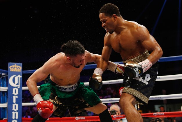 Apr 19, 2014; Washington, DC, USA; Shawn Porter (black gloves and Paulie Malignaggi (red gloves) in action during their bout at DC Armory. Mandatory Credit: Geoff Burke-USA TODAY Sports