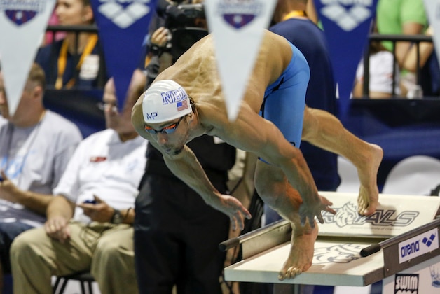 Michael Phelps dives into the pool at the start of the B final 200 meter IM at the Arena Pro Swim Series meet in Charlotte, N.C, Sunday, May 17, 2015. (AP Photo/Nell Redmond)