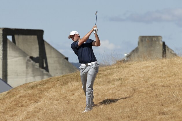Jordan Spieth hits out of the tall fescue grass on the 18th hole during the second round of the U.S. Open golf tournament at Chambers Bay on Friday, June 19, 2015 in University Place, Wash. (AP Photo/Charlie Riedel)