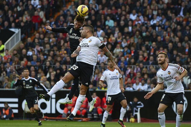 VALENCIA, SPAIN - JANUARY 04:  Nicolas Otamendi of Valencia competes for the ball with Sergio Ramos (L) of Real Madrid during the La Liga match between Valencia CF and Real Madrid CF at Estadi de Mestalla on January 4, 2015 in Valencia, Spain.  (Photo by Manuel Queimadelos Alonso/Getty Images)