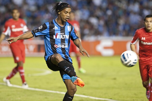 Queretaro´s Ronaldinho, from Brazil, controls the ball at a Mexican soccer league match against Toluca in Queretaro, Mexico, Friday, Sept. 26, 2014. (AP Photo/Christian Palma)