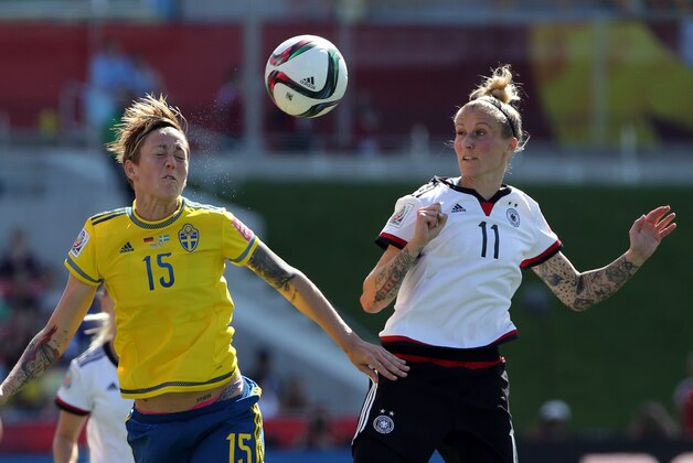 Jun 20, 2015; Ottawa, Ontario, CAN; Sweden midfielder Therese Sjogran (15) heads the ball against Germany forward Anja Mittag (11) during the first half in the round of sixteen in the FIFA 2015 women's World Cup soccer tournament at Lansdowne Stadium. Mandatory Credit: Matt Kryger-USA TODAY Sports