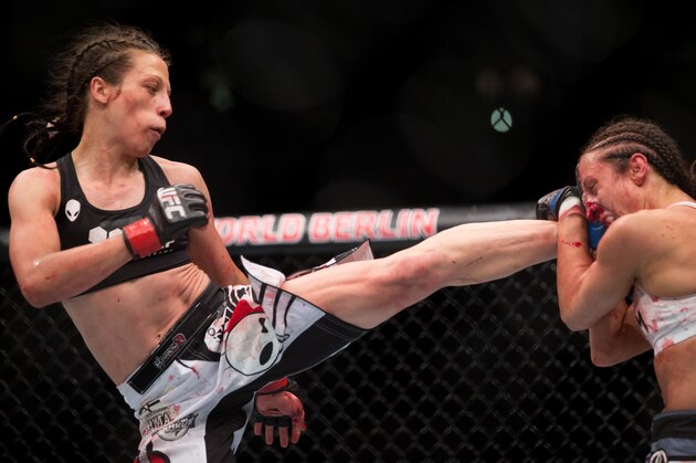 Joanna Jedrzejczyk, left, battles with Jessica Pennei for the women's strawweight title fight during UFC Fight Night in Berlin, Germany, Saturday, June 20, 2015. Jedrzejczyk defeated Pennei through KO/TKO.(AP Photo/Axel Schmidt)