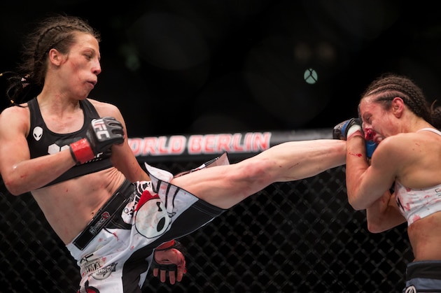 Joanna Jedrzejczyk, left, battles with Jessica Pennei for the women's strawweight title fight during UFC Fight Night in Berlin, Germany, Saturday, June 20, 2015. Jedrzejczyk defeated Pennei through KO/TKO.(AP Photo/Axel Schmidt)