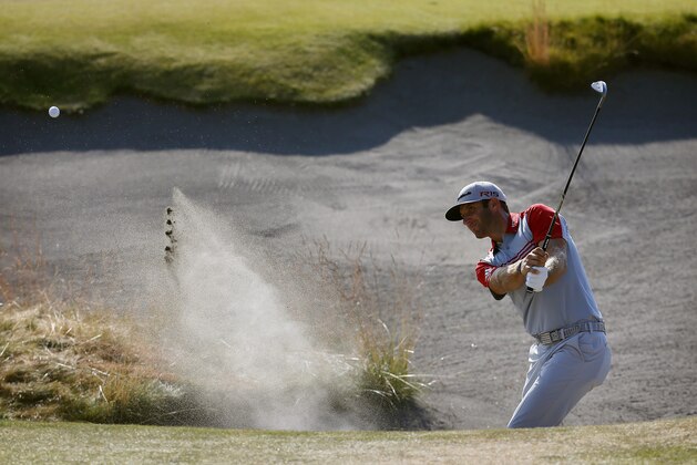 Dustin Johnson hits out of the bunker on the 13th hole during the third round of the U.S. Open golf tournament at Chambers Bay on Saturday, June 20, 2015 in University Place, Wash. (AP Photo/Matt York)