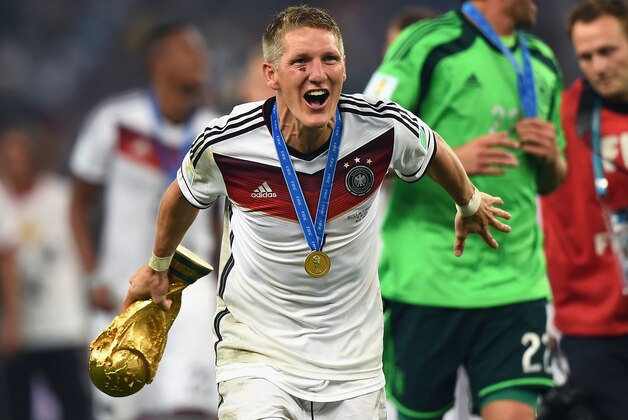RIO DE JANEIRO, BRAZIL - JULY 13:  Bastian Schweinsteiger  of Germany celebrates with the World Cup trophy  after defeating Argentina 1-0 in extra time during the 2014 FIFA World Cup Brazil Final match between Germany and Argentina at Maracana on July 13, 2014 in Rio de Janeiro, Brazil.  (Photo by Laurence Griffiths/Getty Images)