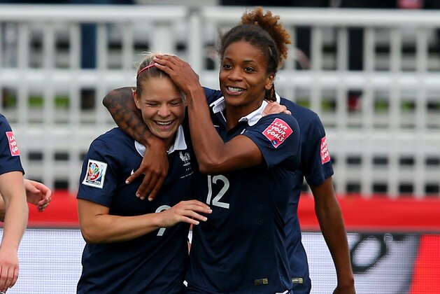 MONCTON, NB - JUNE 09:  Eugenie Le #9 of France is congratulated by teammate Elodie Thomis #12 after Le scored in the first half against England during the FIFA Women's World Cup 2015 Group F match at Moncton Stadium on June 9, 2015 in Moncton, Canada.  (Photo by Elsa/Getty Images)