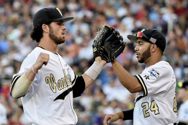 Vanderbilt shortstop Dansby Swanson, left, and Jordan Sheffield (24) exchange high-fives after a double play against TCU in the fourth inning of an NCAA College World Series baseball game at TD Ameritrade Park in Omaha, Neb., Friday, June 19, 2015. (AP Photo/Mike Theiler)