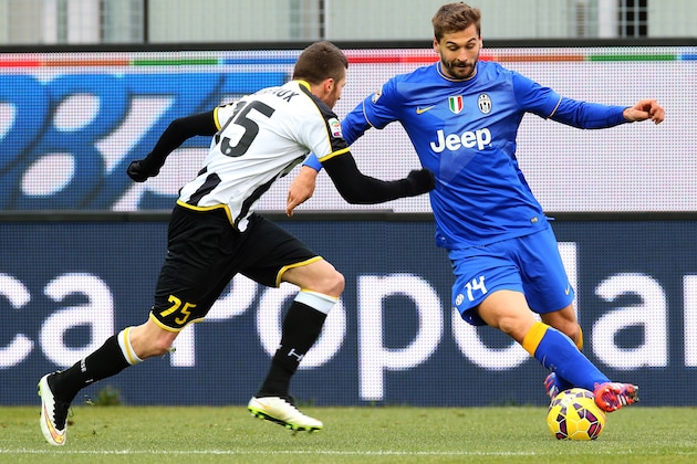 Juventus' Fernando Llorente, right, and Udinese's Thomas Heurtaux fight for the ball during the Serie A soccer match between Udinese and Juventus at the Friuli Stadium in Udine, Italy, Sunday, Feb. 1, 2015. (AP Photo/Paolo Giovannini)