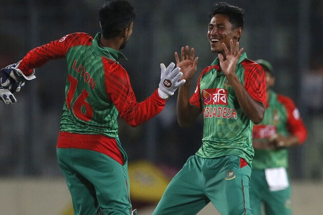 Bangladesh’s Mustafizur Rahman, right, celebrates with his teammate Litton Das,  the dismissal of India’s Ravindra Jadeja during their second one-day international cricket match in Dhaka, Bangladesh, Sunday, June 21, 2015. (AP Photo/ A.M. Ahad)