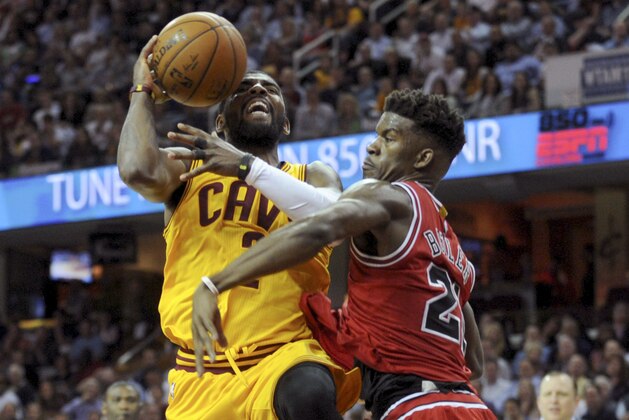 May 6, 2015; Cleveland, OH, USA; Chicago Bulls guard Jimmy Butler (21) defends against Cleveland Cavaliers guard Kyrie Irving (2) during the fourth quarter in game two of the second round of the NBA Playoffs at Quicken Loans Arena. Mandatory Credit: Ken Blaze-USA TODAY Sports