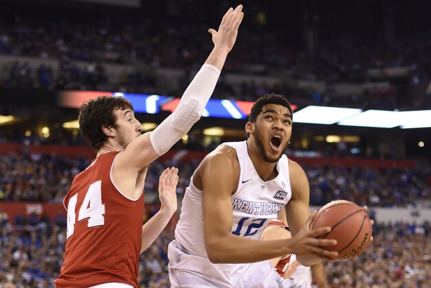 Apr 4, 2015; Indianapolis, IN, USA; Kentucky Wildcats forward Karl-Anthony Towns (12) shoots against Wisconsin Badgers forward Frank Kaminsky (44) in the first half of the 2015 NCAA Men's Division I Championship semi-final game at Lucas Oil Stadium. Mandatory Credit: Bob Donnan-USA TODAY Sports