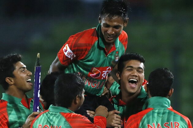 Bangladesh’s players lift Mustafizur Rahman, center, as they celebrate their win over India during their second one-day international cricket match in Dhaka, Bangladesh, Sunday, June 21, 2015. (AP Photo/ A.M. Ahad)