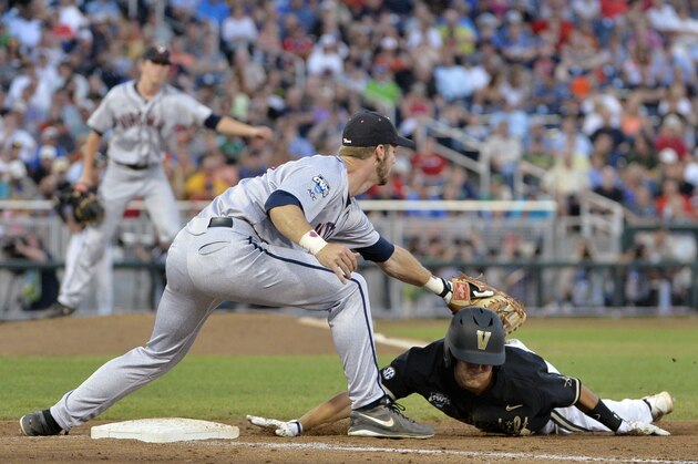 Vanderbilt's Dansby Swanson safely slides back to first against Virginia first baseman Mike Papi in the fifth inning of Game 2 of the best-of-three NCAA baseball College World Series finals in Omaha, Neb., Tuesday, June 24, 2014. (AP Photo/Ted Kirk)
