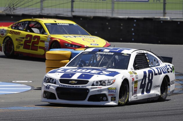 Jimmie Johnson, right, leads Joey Logano, left, during practice for the NASCAR Sprint Cup Series auto race Friday, June 20, 2014, in Sonoma, Calif. (AP Photo/Eric Risberg)