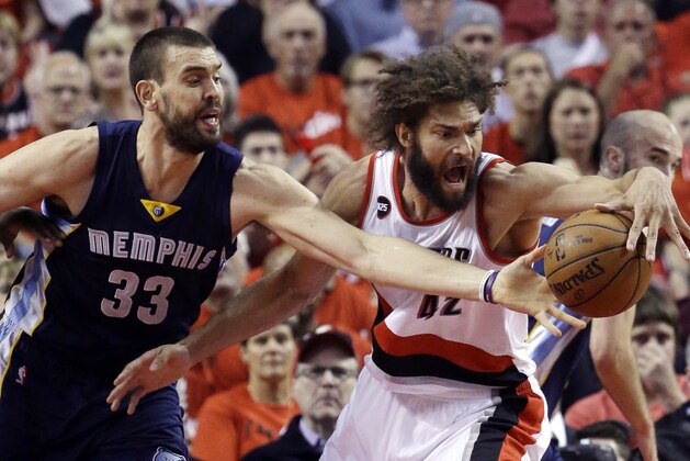 Portland Trail Blazers center Robin Lopez, right, battles for the ball with Memphis Grizzlies center Marc Gasol, from Spain during the first half of Game 4 of a first-round NBA basketball playoff series in Portland, Ore., Monday, April 27, 2015.  (AP Photo/Don Ryan)