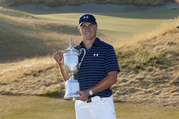 Jordan Spieth holds up the trophy after winning the final round of the U.S. Open golf tournament at Chambers Bay on Sunday, June 21, 2015 in University Place, Wash. (AP Photo/Matt York)