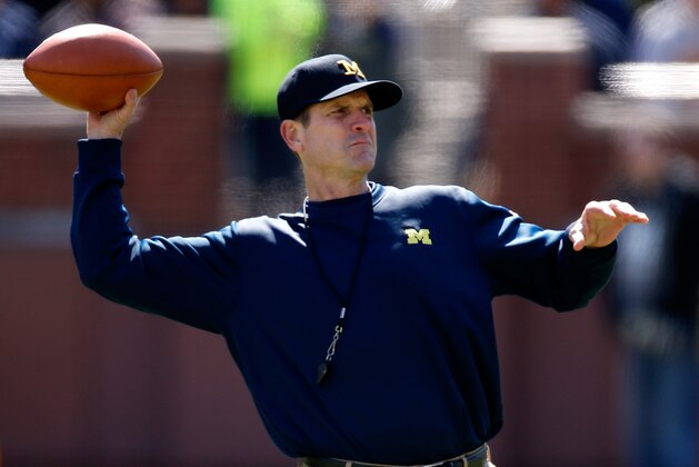 ANN ARBOR, MI - APRIL 04: Head coach Jim Harbaugh of the Michigan Wolverines throws a football during the Michigan Football Spring Game on April 4, 2015 at Michigan Stadium in Ann Arbor, Michigan.  (Photo by Gregory Shamus/Getty Images)