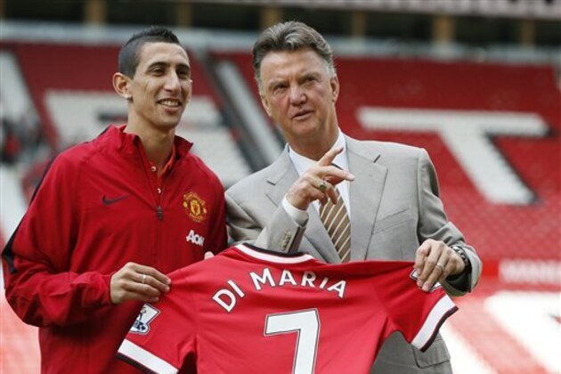 Manchester United's new player Angel Di Maria left, and manager Louis van Gaal, pose for photographers holding his new shirt, at Old Trafford Stadium in Manchester, England, Thursday, Aug. 28, 2014. Manchester United have signed winger Angel Di Maria from Real Madrid for a British record transfer fee of £59.7m. The Argentine winger had a medical in Manchester on Tuesday and has signed a five-year deal. (AP Photo/Alastair Grant)