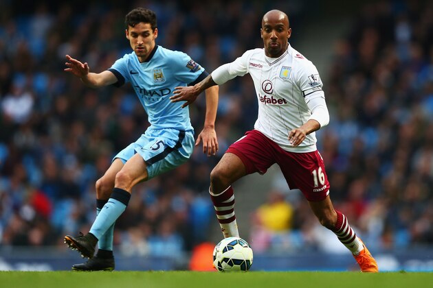 MANCHESTER, ENGLAND - APRIL 25:  Fabian Delph of Aston Villa takes on Jesus Navas of Manchester City during the Barclays Premier League match between Manchester City and Aston Villa at Etihad Stadium on April 25, 2015 in Manchester, England.  (Photo by Clive Brunskill/Getty Images)