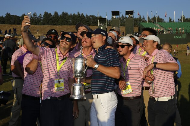 Jordan Spieth poses with the trophy and with USGA interns after winning the U.S. Open golf tournament at Chambers Bay on Sunday, June 21, 2015 in University Place, Wash. (AP Photo/Ted S. Warren)