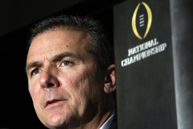 FILE- In this Jan. 13, 2014 file photo, Ohio State head coach Urban Meyer listens to a question during a news conference after the NCAA college football playoff championship game in Dallas. The pundits are talking up the Big Ten league this spring, largely because of the achievements and trend lines in the East Division. There was Ohio State’s national championship under Urban Meyer, Michigan State’s bowl win over a Baylor team that narrowly missed the College Football Playoff, Jim Harbaugh’s hiring at Michigan and Penn State’s rebuilding job under James Franklin. (AP Photo/David J. Phillip, File)