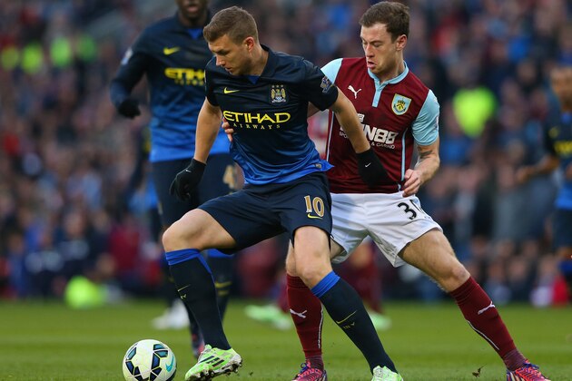 BURNLEY, ENGLAND - MARCH 14:  Edin Dzeko of Manchester City holds off Ashley Barnes of Burnley during the Barclays Premier League match between Burnley and Manchester City at Turf Moor on March 14, 2015 in Burnley, England.  (Photo by Alex Livesey/Getty Images)