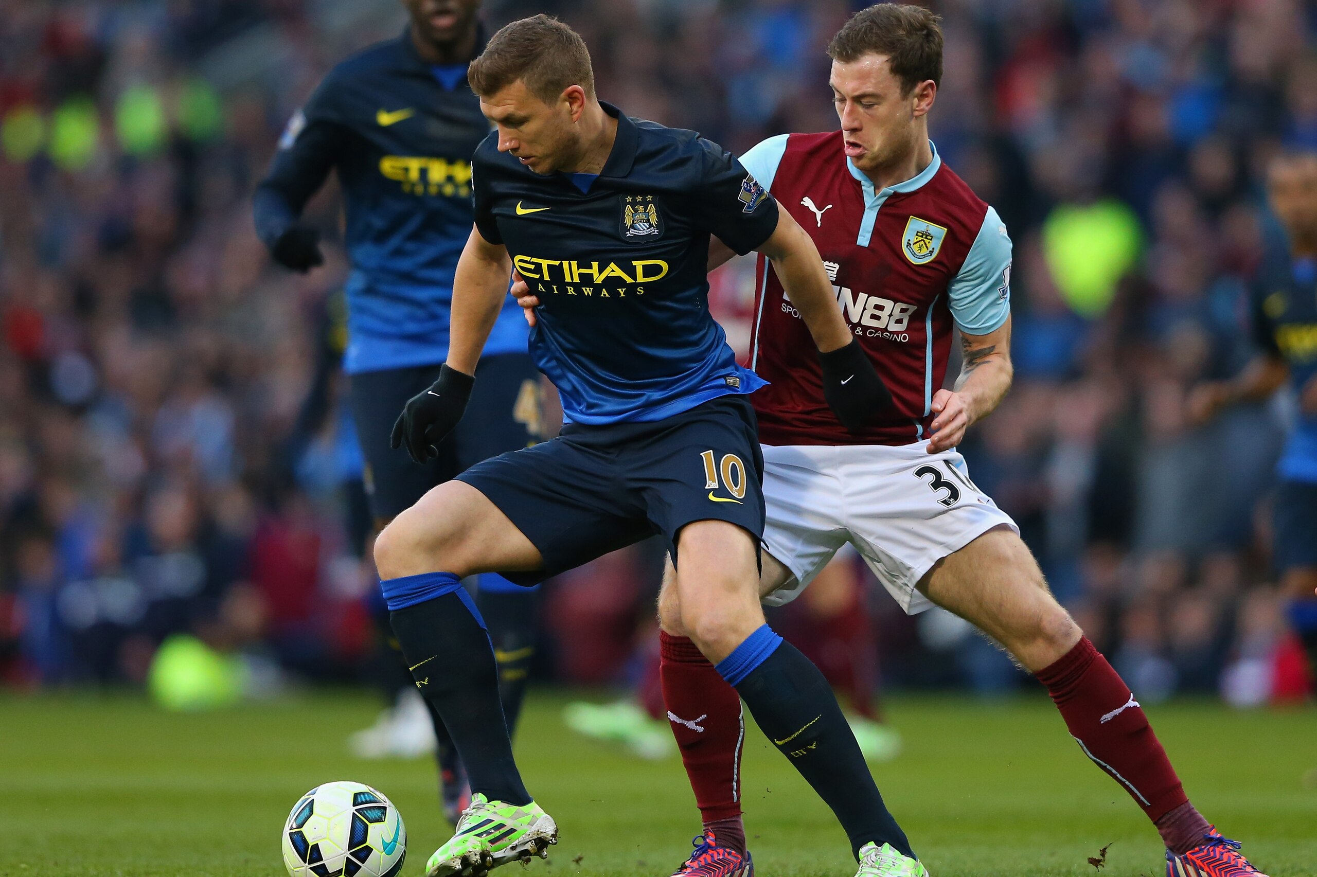 BURNLEY, ENGLAND - MARCH 14:  Edin Dzeko of Manchester City holds off Ashley Barnes of Burnley during the Barclays Premier League match between Burnley and Manchester City at Turf Moor on March 14, 2015 in Burnley, England.  (Photo by Alex Livesey/Getty Images)