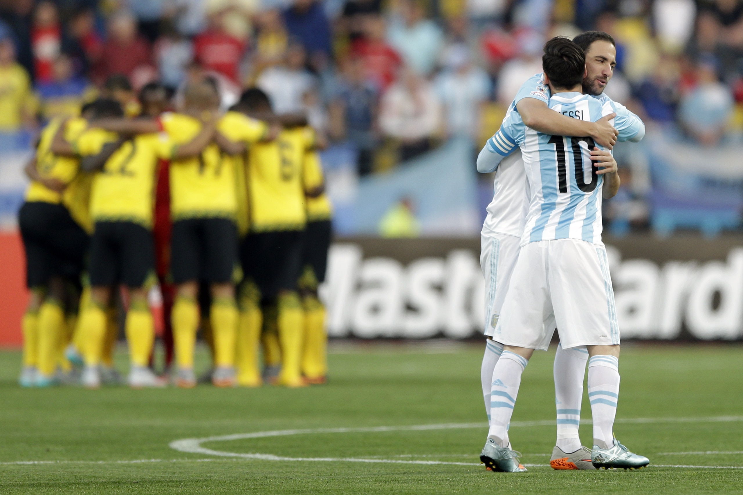 Argentina's Lionel Messi, front right, embraces Gonzalo Higuain at the start of a Copa America Group B soccer match at the Sausalito Stadium in Vina del Mar, Chile, Saturday, June 20, 2015. (AP Photo/Ricardo Mazalan)