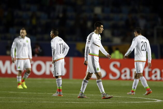 Mexico's players leave the pitch after their  Copa America Group A match against Ecuardor at El Teniente Stadium in Rancagua, Chile, Friday, June 19, 2015. Ecuador won the match 2-1.(AP Photo/Ricardo Mazalan)