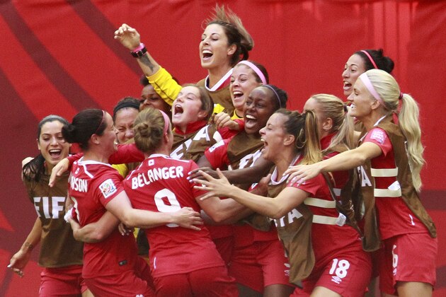 VANCOUVER, BC - JUNE 21: Josee Belanger #9 of Canada is congratulated by teammates after scoring Canada's first goal during the FIFA Women's World Cup Canada 2015 Round 16 match between Switzerland and Canada June 21, 2015 at BC Place Stadium in Vancouver, British Columbia, Canada.  (Photo by Jeff Vinnick/Getty Images)