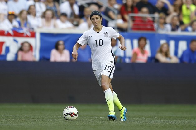 United States midfielder Carli Lloyd wears a protective headband during the second half of an international friendly soccer match against South Korea, Saturday, May 30, 2015, in Harrison, N.J. (AP Photo/Julio Cortez)