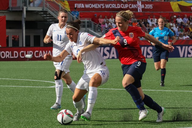 OTTAWA, ON - JUNE 22: Isabell Herlovsen #9 of Norway battles for the ball against Lucy Bronze #12 of England during the FIFA Women's World Cup Canada 2015 round of 16 match between Norway and England at Lansdowne Stadium on June 22, 2015 in Ottawa, Canada.  (Photo by Andre Ringuette/Getty Images)
