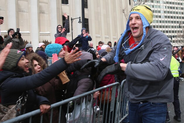 BOSTON, MA - FEBRUARY 04:  Tight end Rob Gronkowski of the New England Patriots high fives fans during a Super Bowl victory parade on February 4, 2015 in Boston, Massachusetts.  The Patriots defeated the Seattle Seahawks 28-24 in Super Bowl XLIX. (Photo by Billie Weiss/Getty Images)