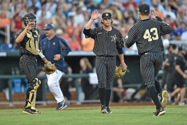 Omaha, NE - JUNE 22:  Pitcher Carson Fulmer #15 of the Vanderbilt Commodores celebrates with teammates after the final out against the Virginia Cavaliers in the fourth inning during game one of the College World Series Championship Series on June 22, 2015 at TD Ameritrade Park in Omaha, Nebraska.  (Photo by Peter Aiken/Getty Images)
