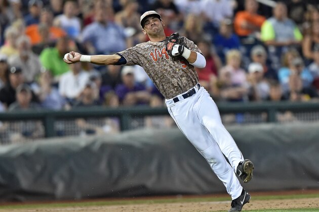 Omaha, NE - JUNE 22:  Third basemen Kenny Towns #9 of the Virginia Cavaliers makes a throw to first against the Vanderbilt Commodores in the sixth inning during game one of the College World Series Championship Series on June 22, 2015 at TD Ameritrade Park in Omaha, Nebraska.  (Photo by Peter Aiken/Getty Images)