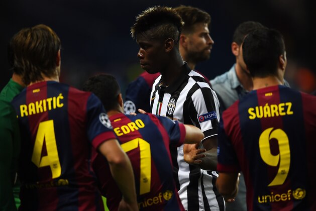 BERLIN, GERMANY - JUNE 06: Paul Pogba of Juventus shakes hands with Pedro Rodriguez of Barcelona as he walks to collect his runners up medal after the UEFA Champions League Final between Juventus and FC Barcelona at Olympiastadion on June 6, 2015 in Berlin, Germany.  (Photo by Laurence Griffiths/Getty Images)
