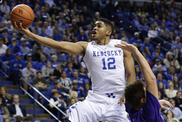 Kentucky's Karl-Anthony Towns (12) shoots next to Grand Canyon's Matt Jackson, right, and during the first half of an NCAA college basketball game, Friday, Nov. 14, 2014, in Lexington, Ky. (AP Photo/James Crisp)