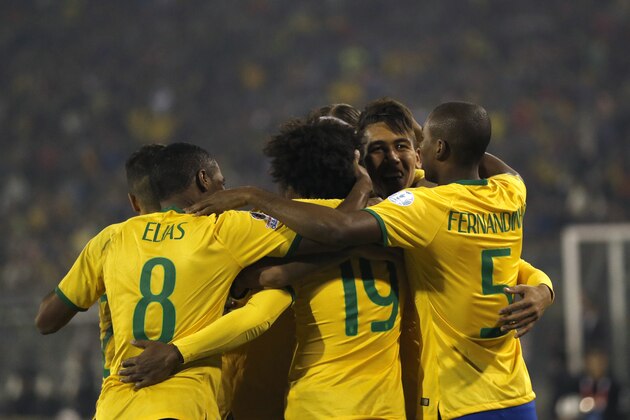 Brazil's Roberto Firmino, second from right,  celebrates with teammates after scoring his team's second goal during a Copa America Group C soccer match at the Monumental stadium in Santiago, Chile, Sunday, June 21, 2015. (AP Photo/Silvia Izquierdo)