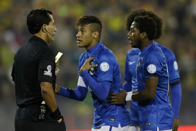 Brazil's Neymar, center, and  Fred argue with the referee  Enrique Osses  from Chile during a Copa America Group C soccer match against Colombia  at the Monumental stadium in Santiago, Chile, Wednesday, June 17, 2015. (AP Photo/Ricardo Mazalan)