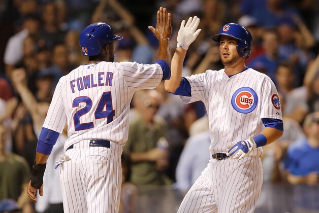 Chicago Cubs' Kris Bryant, right, celebrates with Dexter Fowler after the pair scored on Bryant's two-run home run off Los Angeles Dodgers starting pitcher Clayton Kershaw, during the third inning of a baseball game Monday, June 22, 2015, in Chicago. (AP Photo/Charles Rex Arbogast)