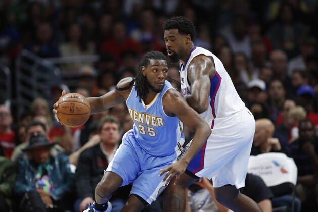 Denver Nuggets' Kenneth Faried, left, dribbles around Los Angeles Clippers' DeAndre Jordan, right, during the first half of an NBA basketball game, Monday, April 13, 2015, in Los Angeles. (AP Photo/Danny Moloshok)