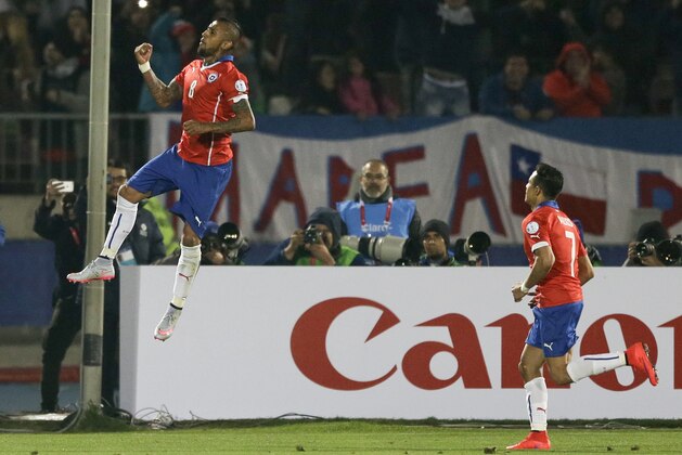 Chile's Arturo Vidal, left, celebrates after scoring on a penalty against Ecuador as teammate Chile's Alexis Sanchez, right, runs towards him during a Copa America Group 1 soccer match at the National Stadium in Santiago, Chile, Thursday, June 11, 2015.(AP Photo/Ricardo Mazalan)