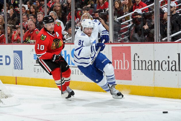 CHICAGO, IL - OCTOBER 19: Phil Kessel #81 of the Toronto Maple Leafs and Patrick Sharp #10 of the Chicago Blackhawks skate around the boards during the NHL game on October 19, 2013 at the United Center in Chicago, Illinois. (Photo by Bill Smith/NHLI via Getty Images)