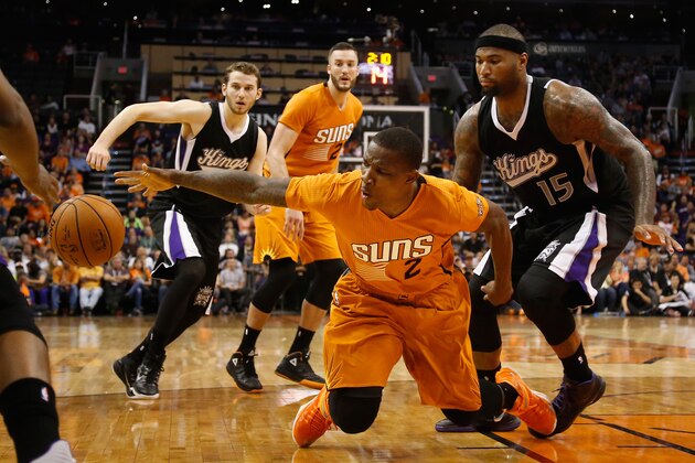PHOENIX, AZ - NOVEMBER 07:  Eric Bledsoe #2 of the Phoenix Suns attempts to control a loose ball defended by DeMarcus Cousins #15 of the Sacramento Kings during the second half of the NBA game at US Airways Center on November 7, 2014 in Phoenix, Arizona. The Kings defeated the Suns 114-112 in double overtime. NOTE TO USER: User expressly acknowledges and agrees that, by downloading and or using this photograph, User is consenting to the terms and conditions of the Getty Images License Agreement.  (Photo by Christian Petersen/Getty Images)