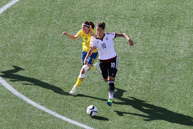 OTTAWA, ON - JUNE 20: Kosovare Asllani #9 of Sweden tries to catch Dzsenifer Marozsan #10 of Germany during the FIFA Women's World Cup Canada 2015 round of 16 match between Germany and Sweden at Lansdowne Stadium on June 20, 2015 in Ottawa, Canada.  (Photo by Jana Chytilova/Getty Images)