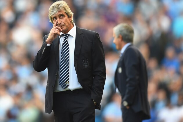 MANCHESTER, ENGLAND - SEPTEMBER 21: Manuel Pellegrini of Manchester City looks on in front of  Jose Mourinho of Chelsea during the Barclays Premier League match between Manchester City and Chelsea at Etihad Stadium on September 21, 2014 in Manchester, England.  (Photo by Laurence Griffiths/Getty Images)