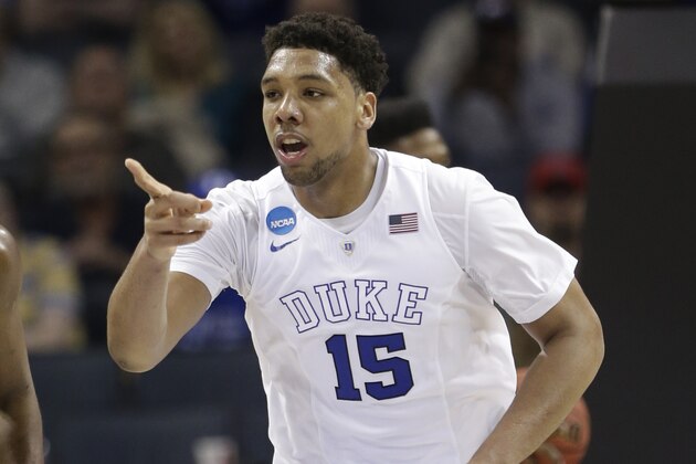Duke's Jahlil Okafor (15) points to a teammate after a basket against San Diego State during the second half of an NCAA tournament college basketball game in the Round of 32 in Charlotte, N.C., Sunday, March 22, 2015. Duke won 68-49. (AP Photo/Gerald Herbert)